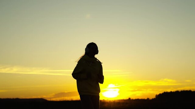silhouette of a girl running at sunset, love sports in active body movement, cardio training outdoors in morning dawn, achieve success and be healthy person, problem of cellulite and fullness of legs.
