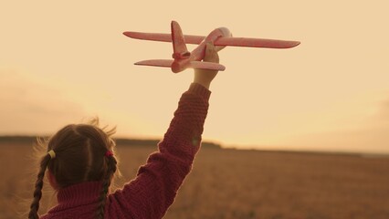 happy child runs sunset with toy airplane his hand, childhood dream flying, kid soars air...