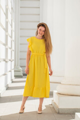 Full body portrait of a red-haired woman in yellow dress