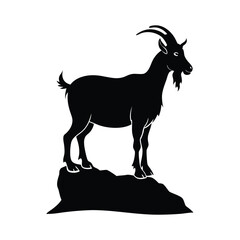 silhouette of goat standing on rock