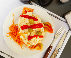 Appetizing salad with olives, tomatoes, paprika and carrots. High quality photo