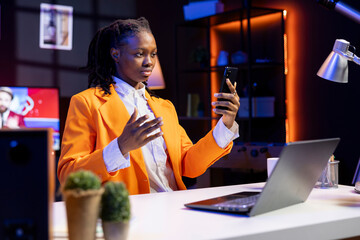 Woman checking up on close friends during phone video conference meeting over the internet. Girl enjoying time together with friend in online video call session on smartphone while at home