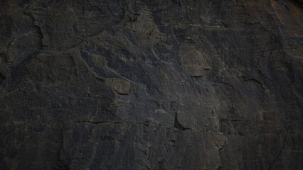 A textured stone background with a brutal, monolithic rock formation, cracks, and fragments. Perfect for design templates or banners, showcasing raw power and natural beauty.