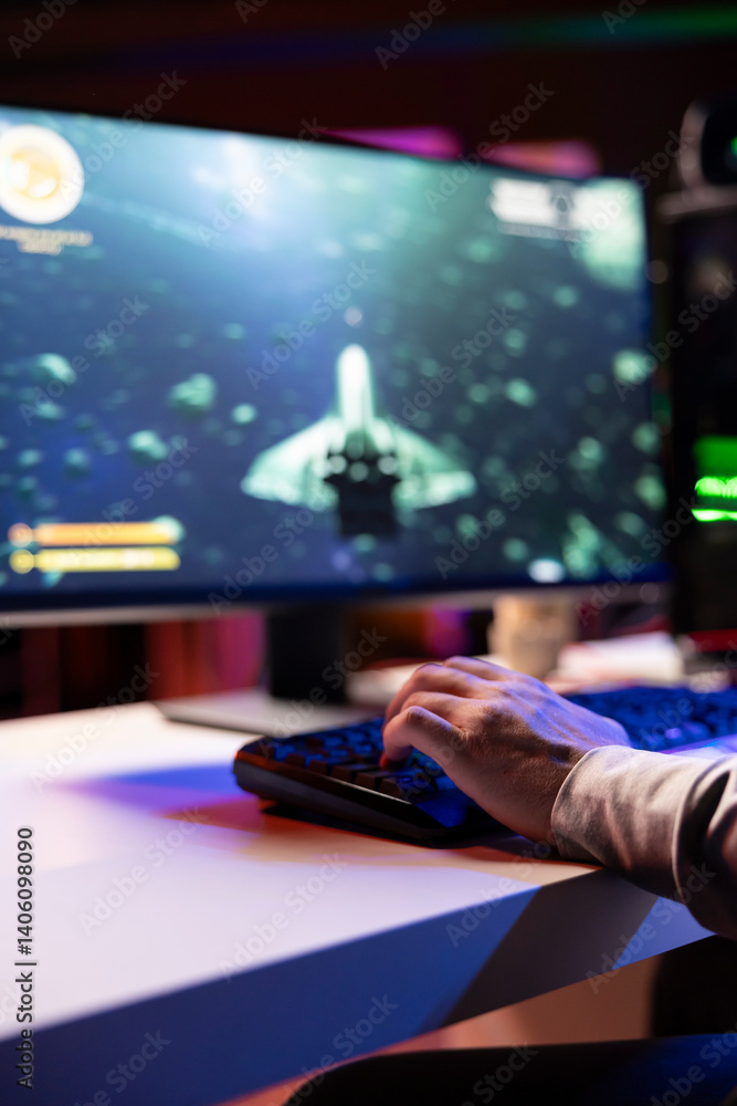 Poster man using gaming keyboard to fly spaceship in sf videogame, close up on computer screen. gamer using