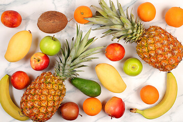 Summer tropical fruits on marble table, source of vitamin C, banner for shop, healthy vegan...