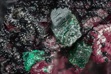 Dioptase mineral (cobaltocalcite pink; malachite black spherulites) copper silicate. Microphotography with high magnification, photo scale 10X
