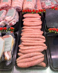 Pork sausage links on display in traditional british butcher shop