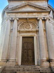 Stairs, white columns, wooden doors