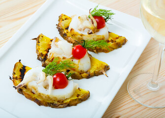 Dish of Mediterranean cuisine - cuttlefish grilled with pineapple and cherry tomatoes and sweet and sour sauce Chile