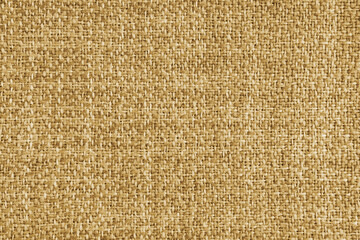 Upholstery yellow colored jacquard fabric coarse weave texture. Textile background, furniture textile material, wallpaper, backdrop. Cloth structure close up, macro