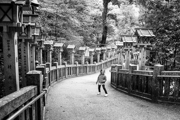 A little girl walking downhill at a shrine