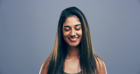 Happy, smile and face of Indian woman in studio with confidence, pride and cheerful. Relax, beauty and portrait of Asian person with excited facial expression, reaction and emoji on gray background