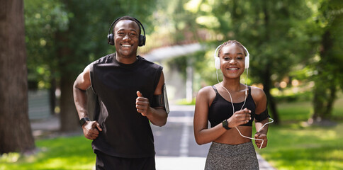 Couples Active Leisure. Cheerful Black Guy And Girl Jogging In Summer Park Together, Enjoying...