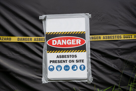 Asbestos danger hazard sign, building site, warning house demolition fire, asbestosis lung cancer risk