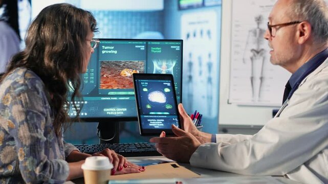 Meeting between doctor and patient to examine MRI scan showing a tumor, exploring treatment options, including immunotherapy, chemotherapy and preventative medicine. Risk factors. Camera B.