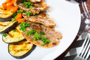 Appetizing grilled lamb chops with vegetable garnish of eggplant, carrots and greens