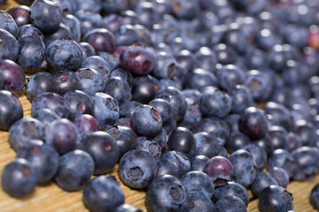 Close up of fresh blueberries on wooden background