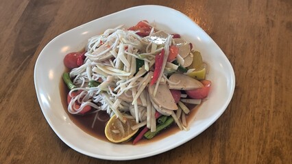 Spicy papaya salad is a spicy dish in Thailand.