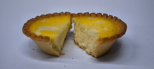 Egg tarts that are crispy on the outside and soft on the inside. Egg tarts that have a rich and creamy egg aroma. Egg tarts on white background.