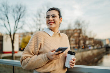 Young caucasian businesswoman use cellphone to talk or send voice messages
