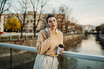 Young caucasian businesswoman use cellphone to talk or send voice messages
