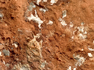 Texture of weathered red stone showing minerals and earthy tones