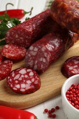 Different smoked sausages and spices on table, closeup