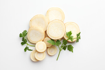 Pieces of parsley roots and leaves on white background, flat lay