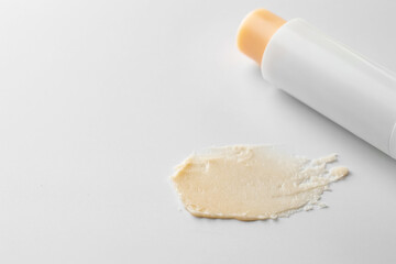 Stick of lip balm and sample on white background, closeup. Space for text