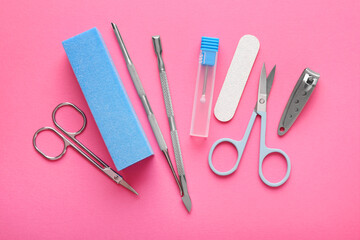 Set of different manicure tools on bright pink background, flat lay