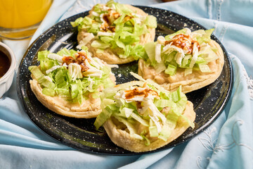 Traditional mexican food sopes, made with corn, beans, salsa and cheese