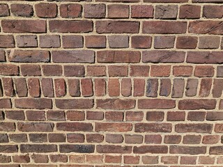 Obraz premium Texture background of the rough texture a red and brown brick wall.