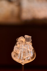 Ice cubes in a glass on a dark background. Shallow depth of field