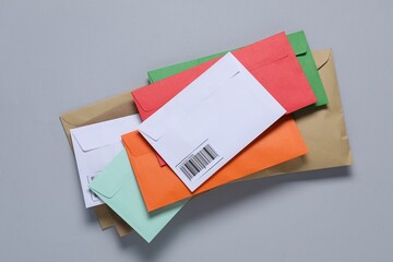 Different paper envelopes on light grey background, top view. Post office