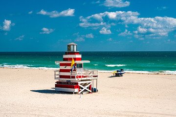 Fototapeta premium Miami pier. Jetty lifeguard tower on Miami Beach. Scenic view of Miami Beach coastline. Famous South Beach lifeguard. Tropical paradise in Miami. Art Deco lifeguard on Miamis beach.
