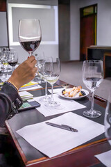 Sommelier evaluating wine during tasting session in conference room