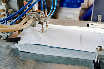 Efficient automatic pneumatic paper sheet feeder in action, transforming stacks of paper for...