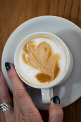 cup of coffee with a heart shaped cookie