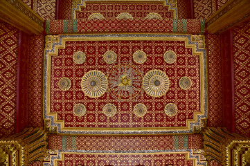 BANGKOK, THAILAND - April 14, 2025 : Golden Thai Ornament Background on Colorful Thai Temple wall...