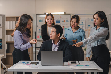 Office workers expressing frustration and blaming their manager for poor results, pointing fingers during a tense presentation in a crowded meeting room filled with stress and conflict