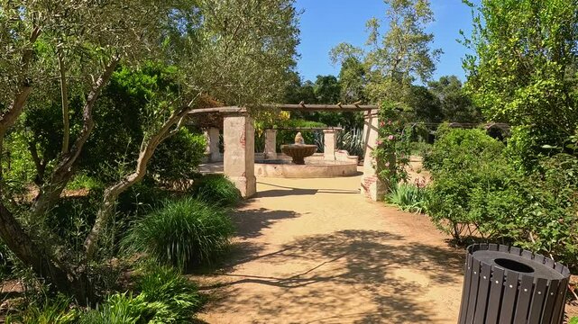 footage of a water fountain with lush green trees and plants and colorful flowers at Descanso Gardens La Canada Flintridge California USA