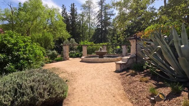 footage of a water fountain with lush green trees and plants and colorful flowers at Descanso Gardens La Canada Flintridge California USA