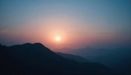 Fototapeta premium Sunset Silhouette over Mountains: A breathtaking vista unfolds as the setting sun casts a warm glow upon the majestic mountain range, painting the sky in hues of orange, pink, and purple.