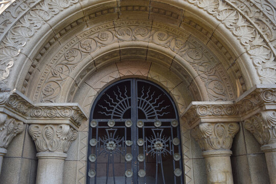 Entrance to a building with a romantic architectural style with a metal door with crosses
