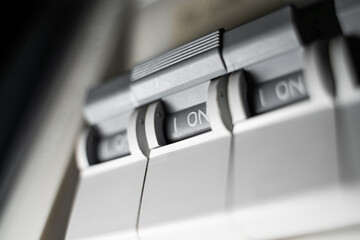 Close-up of a switchboard with a toggle switch turned on