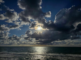 Dramatic Sunset Over the Ocean with Moody Clouds
