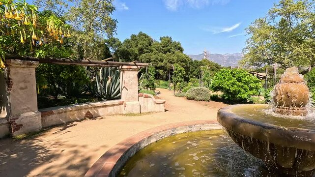 footage of a water fountain with lush green trees and plants and colorful flowers at Descanso Gardens La Canada Flintridge California USA