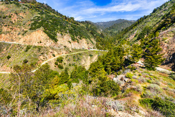 Fototapeta premium Stunning coastal landscape along California's Highway 1, featuring rugged rocky formations, and the vast blue ocean. A breathtaking natural scene showcasing the raw beauty of the Pacific coastline
