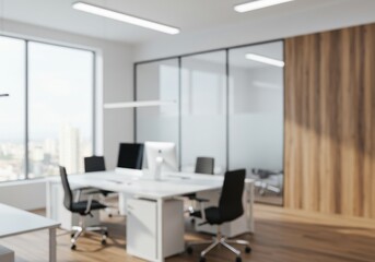 A blurred view of a modern office space with desks chairs and large windows and wooden wall panels