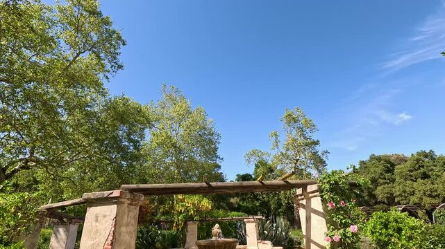footage of a water fountain with lush green trees and plants and colorful flowers at Descanso Gardens La Canada Flintridge California USA